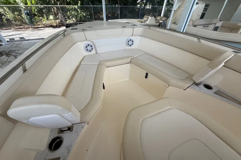 Slide: The Image of Luxurious interior of 2027 Scout 240 XSF boat with beige seating and speakers. - 1