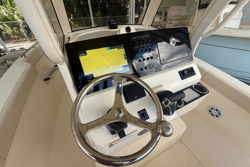 Slide: The Image of Steering console of 2027 Scout 240 XSF boat with navigation display and controls. - 7