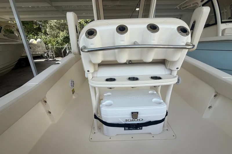 Slide: The Image of 2027 Scout 240 XSF boat interior with rod holders and Igloo cooler. - 10