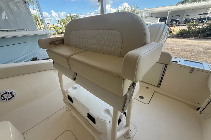Slide: The Image of 2027 Scout 240 XSF boat interior with cushioned seating and storage. - 9