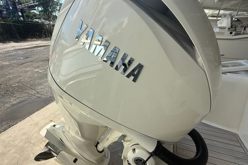 Slide: The Image of Yamaha outboard motor on a 2027 Scout 240 XSF boat, dockside view. - 17