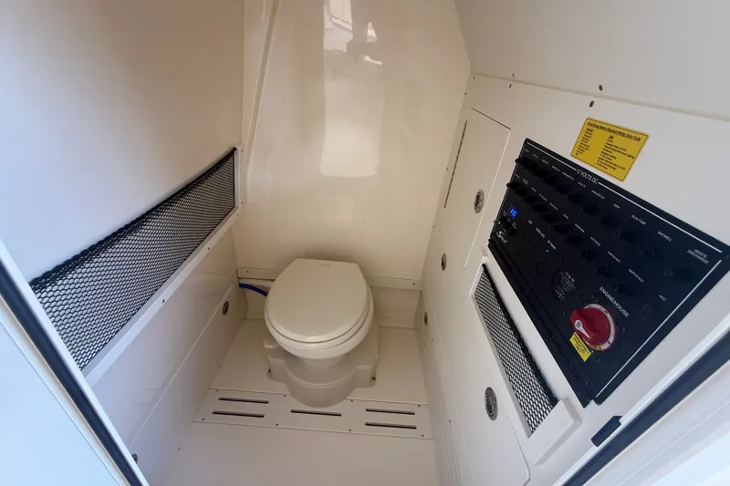 Slide: The Image of 2027 Scout 240 XSF boat interior with toilet and control panel. - 19