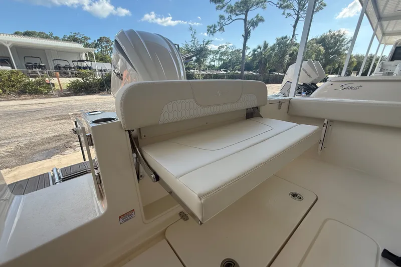 Slide: The Image of 2027 Scout 240 XSF boat interior with foldable seating and outboard motor. - 11