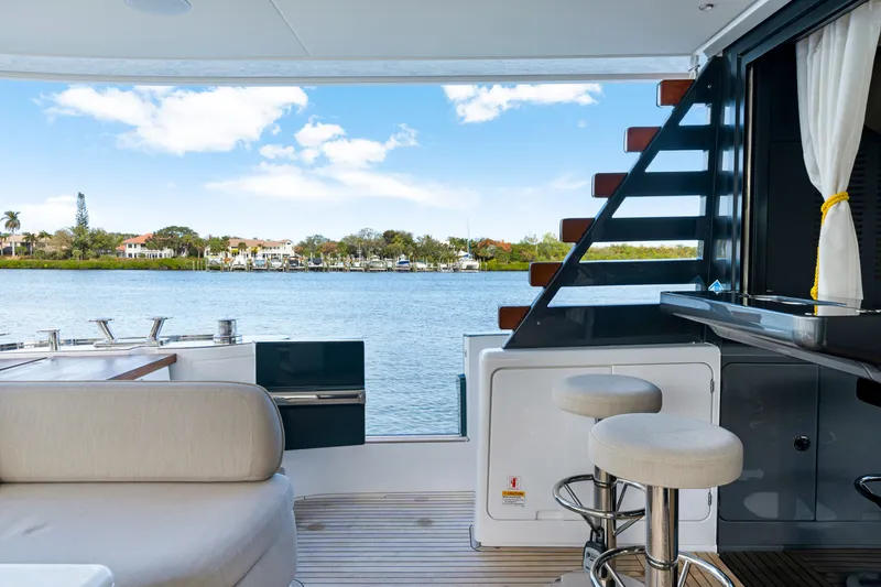 Slide: The Image of The 2024 Azimut Magellano features a stylish deck overlooking calm waters with modern amenities. - 15