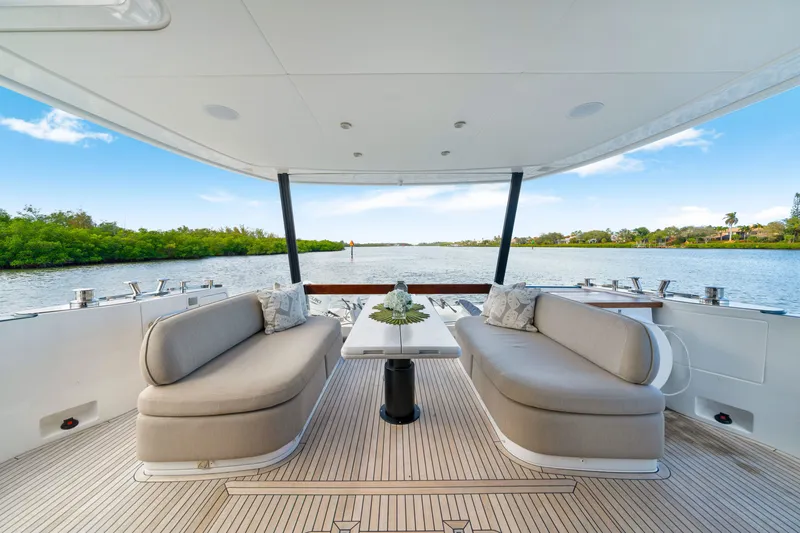 Slide: The Image of The image shows the aft deck of a 2024 Azimut Magellano with elegant seating and a table. - 16
