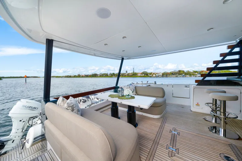 Slide: The Image of The 2024 Azimut Magellano features a spacious deck with comfortable seating and a dining table. - 14