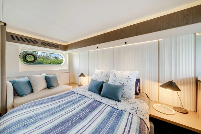 Slide: The Image of The image shows a luxurious cabin with a large bed, decorative pillows, and a window. - 31