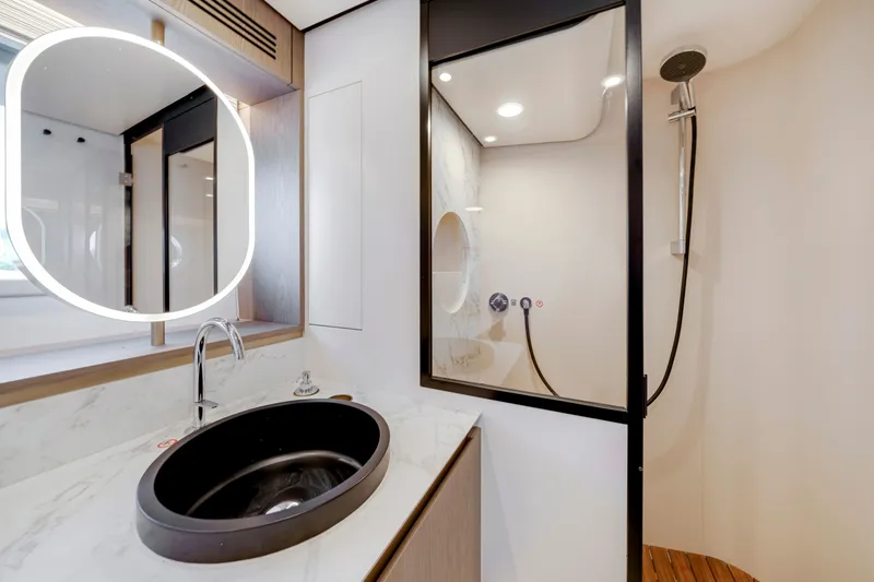 Slide: The Image of Modern bathroom with round sink and shower cabin on an Azimut Magellano 2024. - 35
