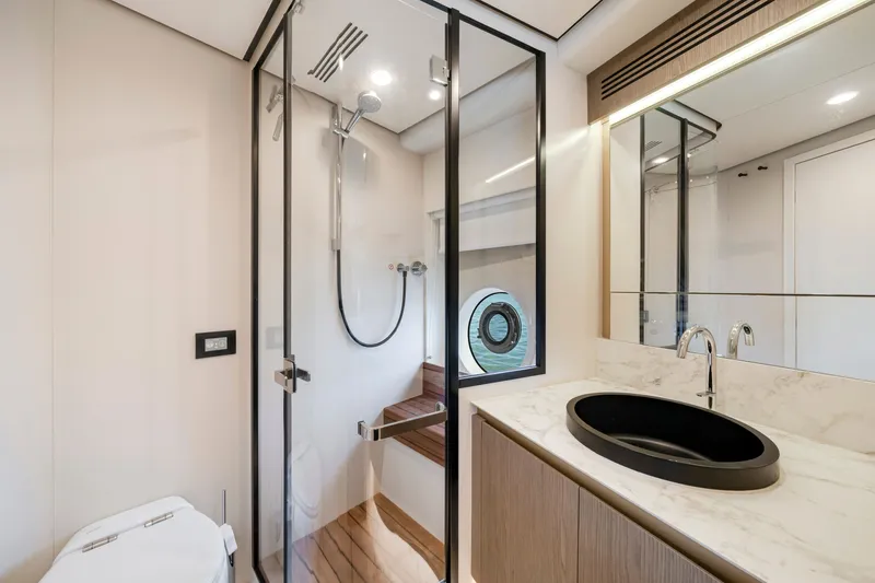 Slide: The Image of Modern bathroom on a 2024 Azimut Magellano yacht with glass shower and stylish sink. - 38