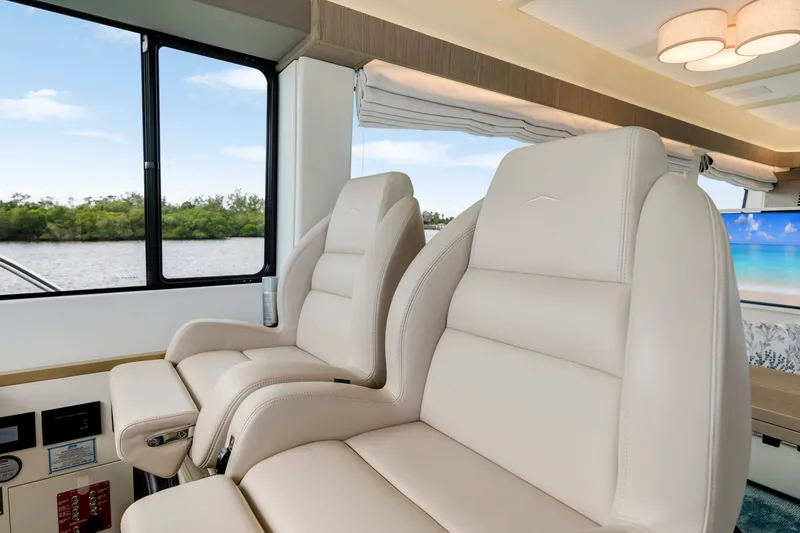 Slide: The Image of Interior of the 2024 Azimut Magellano with luxurious cream leather seats and large windows. - 28