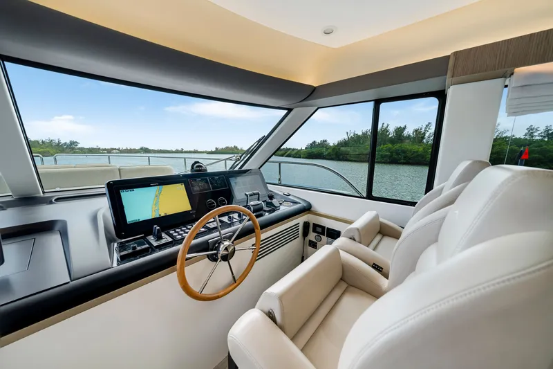 Slide: The Image of The image shows the cockpit of a 2024 Azimut Magellano with modern navigation systems and comfortable seating. - 26