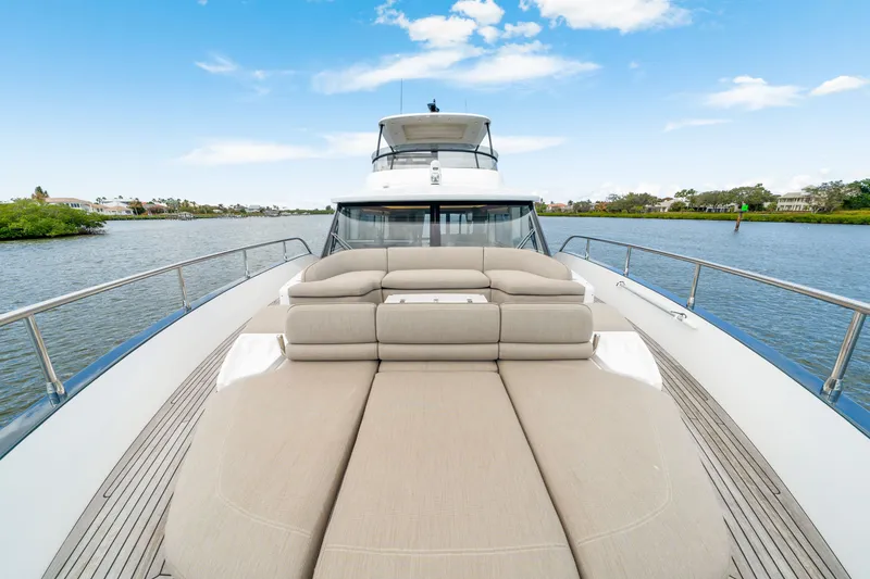 Slide: The Image of The 2024 Azimut Magellano features a spacious sun deck with comfortable loungers and a clear view of the water. - 42