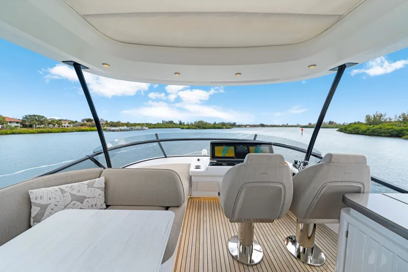 Slide: The Image of The image shows the cockpit of a 2024 Azimut Magellano with two seats and a helm station. - 45
