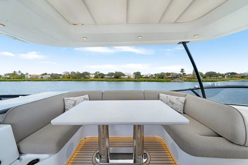 Slide: The Image of The 2024 Azimut Magellano features an elegant seating area with a table, overlooking the water. - 48