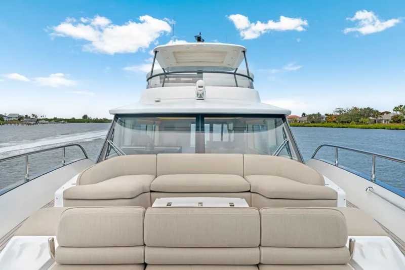 Slide: The Image of The image shows the stern of a 2024 Azimut Magellano with beige sofa and blue sky. - 43