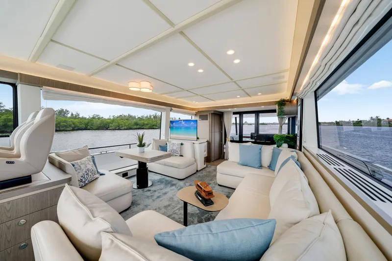 Slide: The Image of Luxurious salon of the 2024 Azimut Magellano with large windows, comfortable sofas, and modern decor. - 25