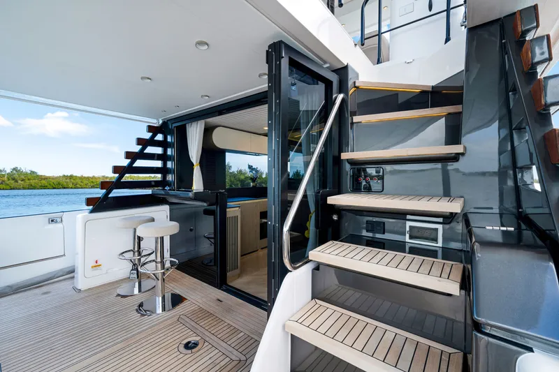 Slide: The Image of The 2024 Azimut Magellano features an elegant staircase, a bar, and a modern interior. - 13