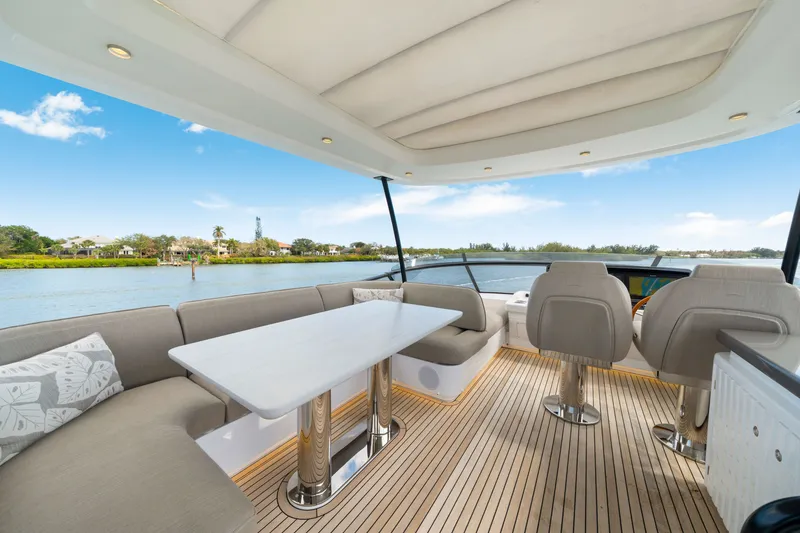 Slide: The Image of The image shows the deck of a 2024 Azimut Magellano with elegant seating and a table. - 44