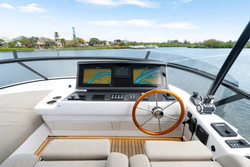Slide: The Image of The cockpit of the 2024 Azimut Magellano with modern navigation system and wooden steering wheel. - 47