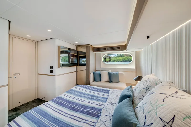 Slide: The Image of Interior of the 2024 Azimut Magellano with cozy bed and window. - 32