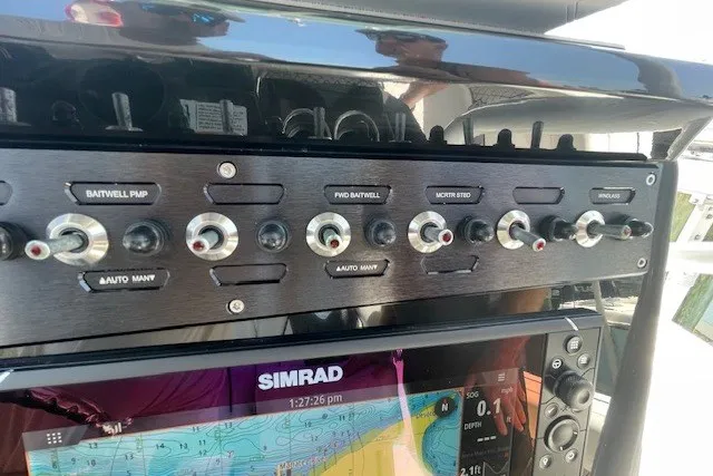 Slide: The Image of Control panel of 2023 Wellcraft 242 Fisherman boat with Simrad navigation display. - 83