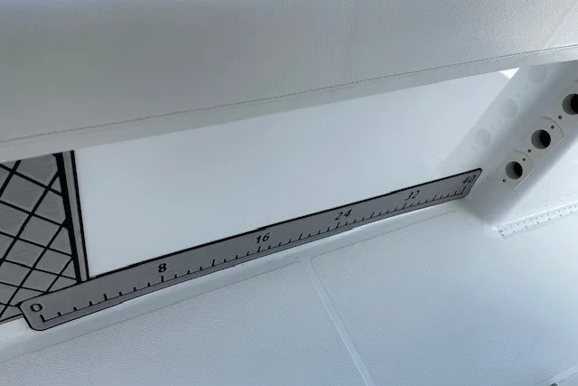 Slide: The Image of 2023 Wellcraft 242 Fisherman boat interior with built-in measuring ruler. - 73