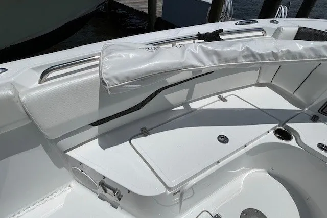 Slide: The Image of 2023 Wellcraft 242 Fisherman boat interior with white seating and storage compartments. - 69