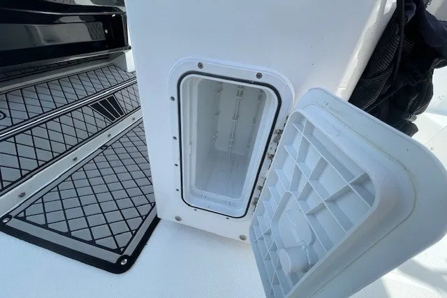 Slide: The Image of Open storage compartment on 2023 Wellcraft 242 Fisherman boat, featuring non-slip flooring. - 22