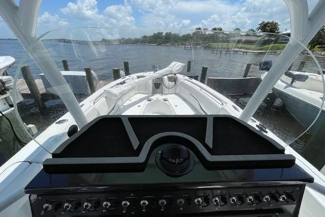 Slide: The Image of 2023 Wellcraft 242 Fisherman boat dashboard with scenic waterfront view. - 37