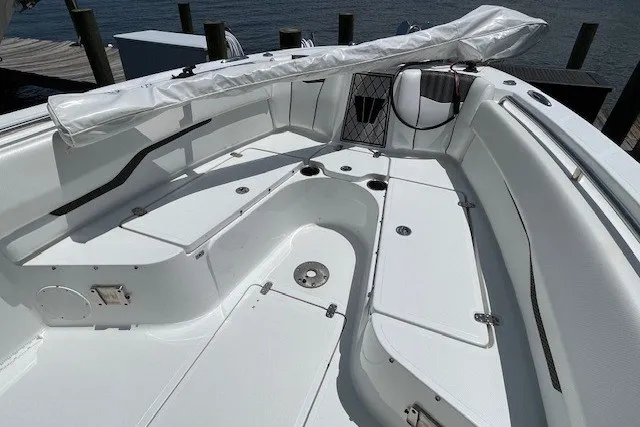 Slide: The Image of 2023 Wellcraft 242 Fisherman boat interior with white seating and storage compartments. - 62
