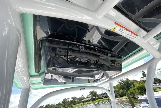 Slide: The Image of 2023 Wellcraft 242 Fisherman boat console with electronics, under a sleek canopy. - 35