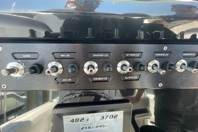 Slide: The Image of Control panel of 2023 Wellcraft 242 Fisherman boat with various switches and display. - 81