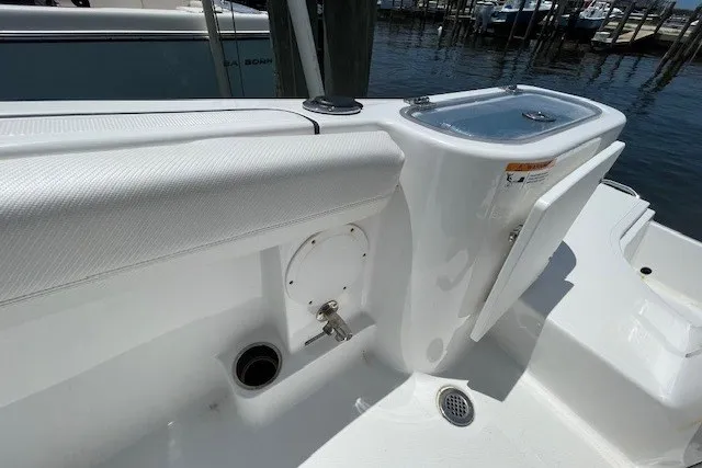 Slide: The Image of 2023 Wellcraft 242 Fisherman boat interior with seating and storage compartments. - 12