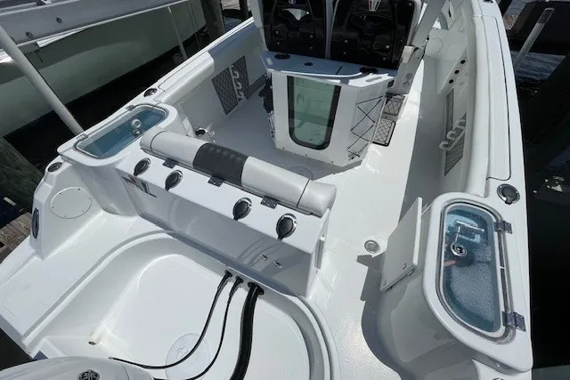 Slide: The Image of 2023 Wellcraft 242 Fisherman boat interior with seating, storage, and control panel. - 9
