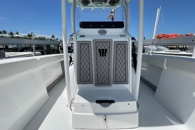 Slide: The Image of 2023 Wellcraft 242 Fisherman boat, center console view, docked under clear blue sky. - 44