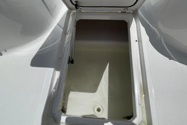 Slide: The Image of Open storage compartment on 2023 Wellcraft 242 Fisherman boat. - 63