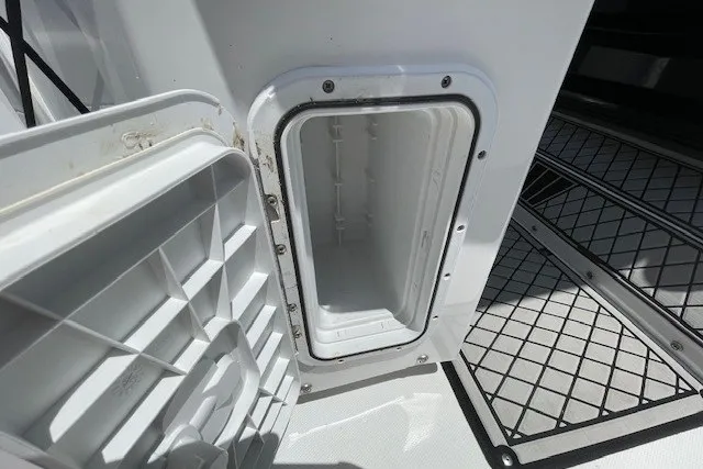 Slide: The Image of Open storage compartment on 2023 Wellcraft 242 Fisherman boat deck. - 20