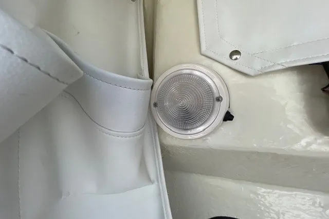 Slide: The Image of Interior detail of 2023 Wellcraft 242 Fisherman boat, featuring a circular light fixture. - 53