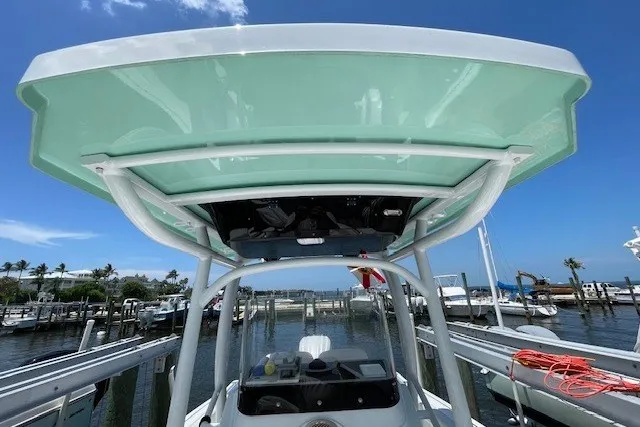Slide: The Image of 2023 Wellcraft 242 Fisherman boat docked at marina under clear blue sky. - 71