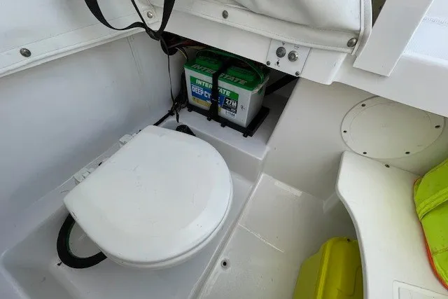Slide: The Image of 2023 Wellcraft 242 Fisherman boat interior with battery compartment and seating area. - 42
