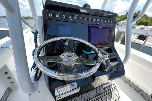Slide: The Image of 2023 Wellcraft 242 Fisherman boat dashboard with steering wheel and electronic displays. - 34