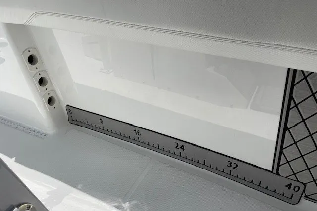 Slide: The Image of 2023 Wellcraft 242 Fisherman boat interior with built-in measuring ruler. - 72