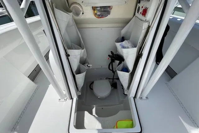 Slide: The Image of 2023 Wellcraft 242 Fisherman boat interior with storage and marine toilet. - 43