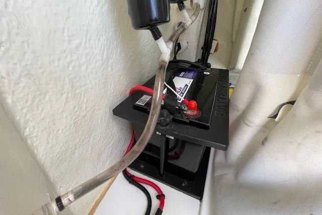 Slide: The Image of Battery compartment of 2023 Wellcraft 242 Fisherman boat, featuring wiring and connections. - 59