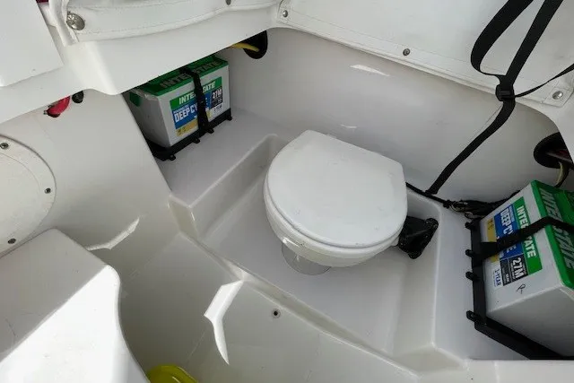 Slide: The Image of 2023 Wellcraft 242 Fisherman boat interior with toilet and batteries. - 50