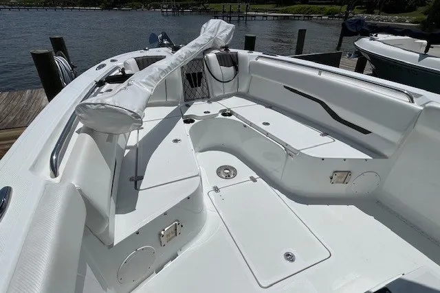 Slide: The Image of 2023 Wellcraft 242 Fisherman boat interior with seating and storage, docked by the water. - 55