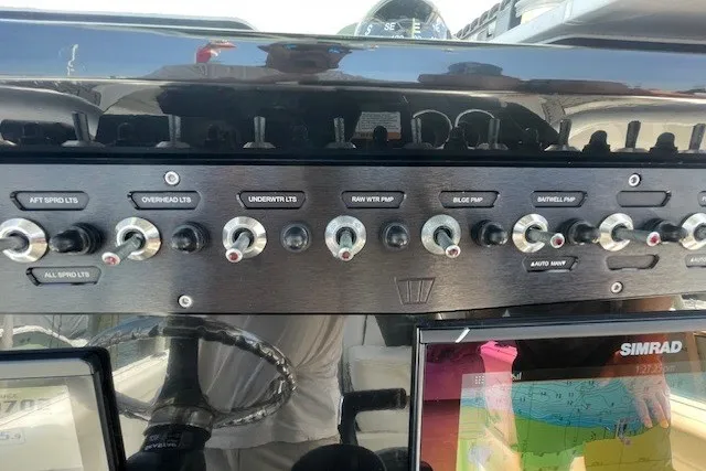 Slide: The Image of Control panel of 2023 Wellcraft 242 Fisherman boat with switches and navigation display. - 82