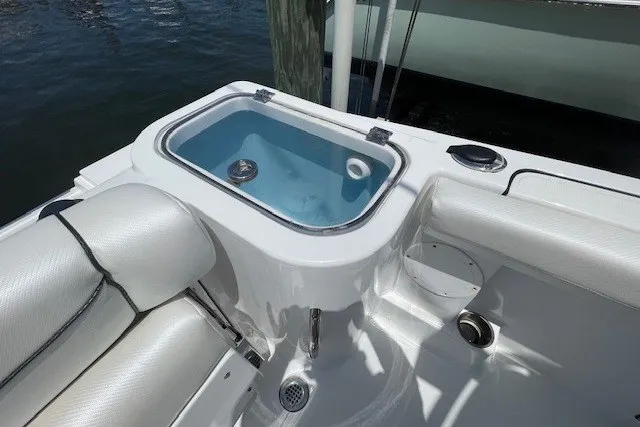 Slide: The Image of 2023 Wellcraft 242 Fisherman boat interior with livewell and seating. - 13