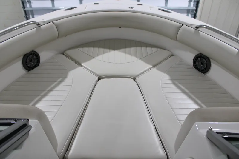 Slide: The Image of 2005 Robalo R227 Dual Console boat interior with cushioned seating and speakers. - 29