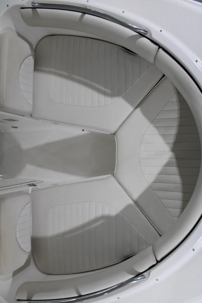 Slide: The Image of 2005 Robalo R227 Dual Console boat interior with white cushioned seating. - 32